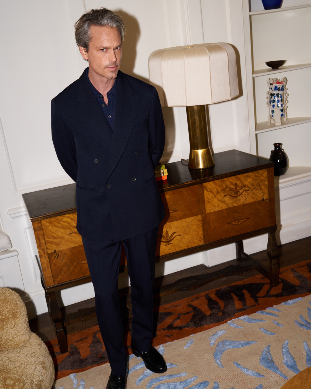 Model wears Casely-Hayford double breasted Yinka suit in Navy. 