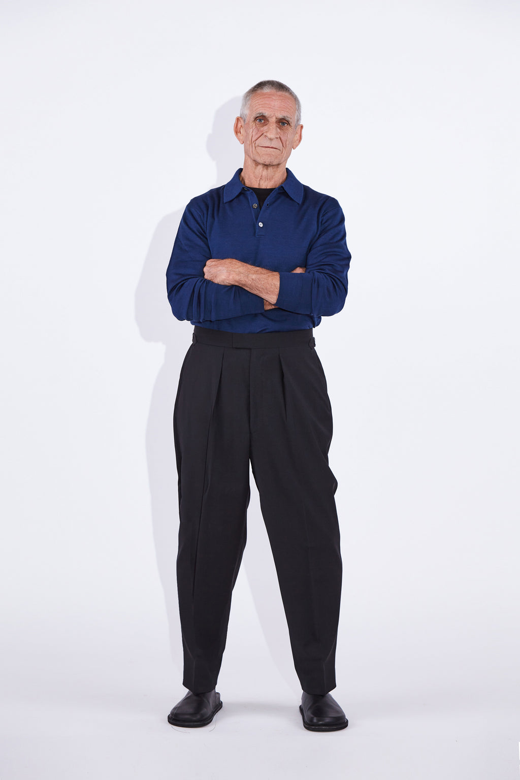 Model wears Casely-Hayford Ezra Black Fresco Relaxed Tapered Leg Wool Trousers. 