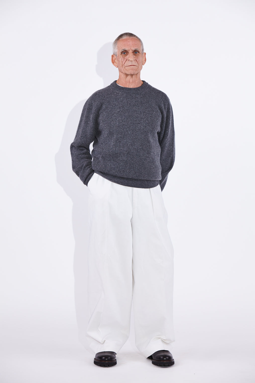 Model wears Casely-Hayford Rory Derby Grey Cashmere Crew Neck Knit.