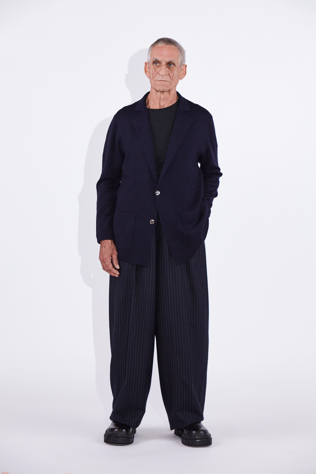 Model wears Casely-Hayford Cole Navy Knitted Notch Lapel Blazer. 