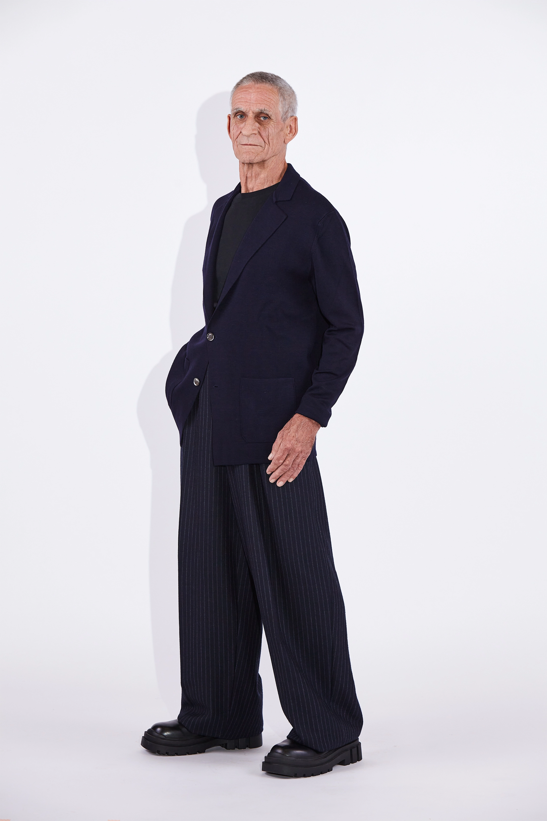 Model wears Casely-Hayford Cole Navy Knitted Notch Lapel Blazer.