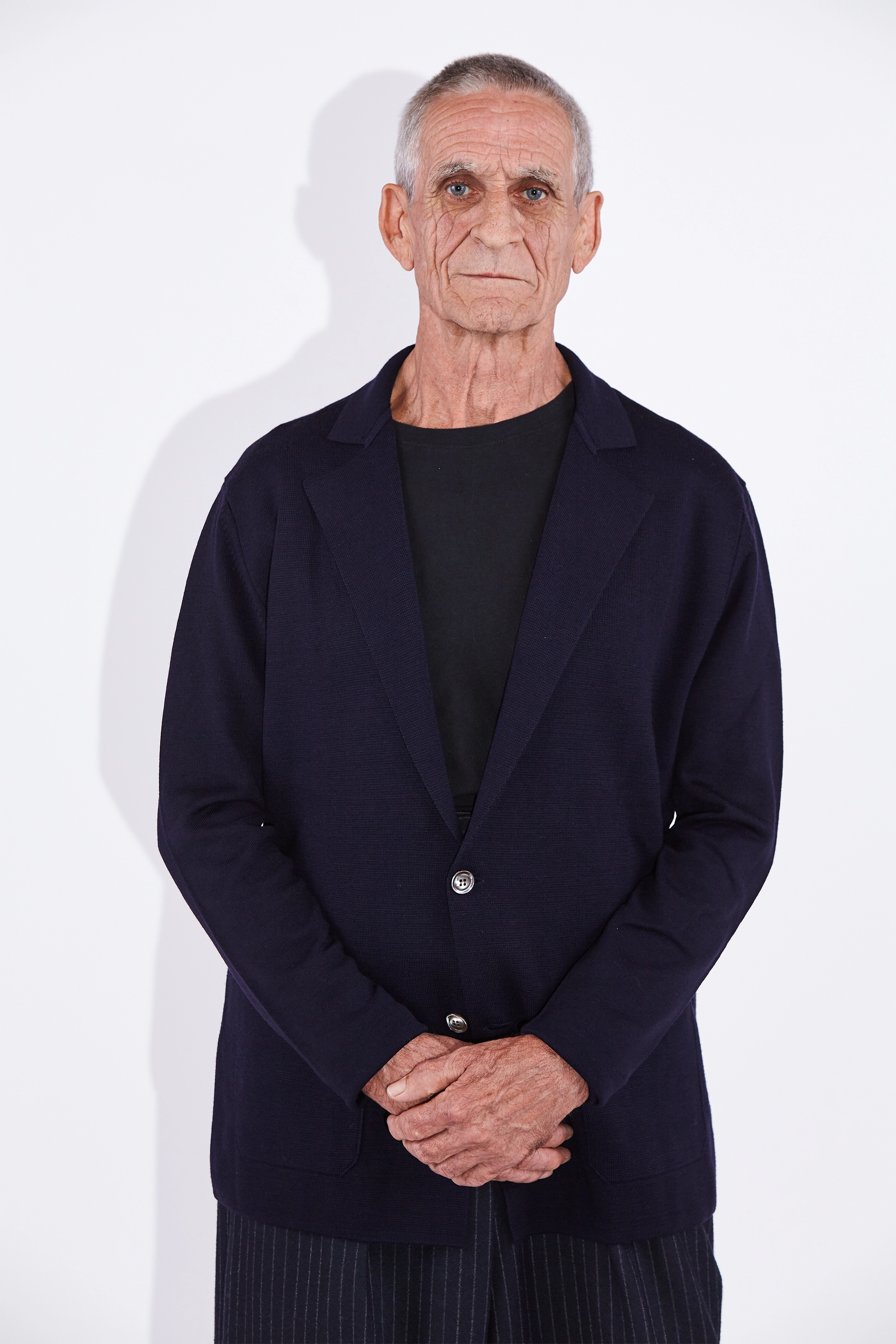 Model wears Casely-Hayford Cole Navy Knitted Notch Lapel Blazer.