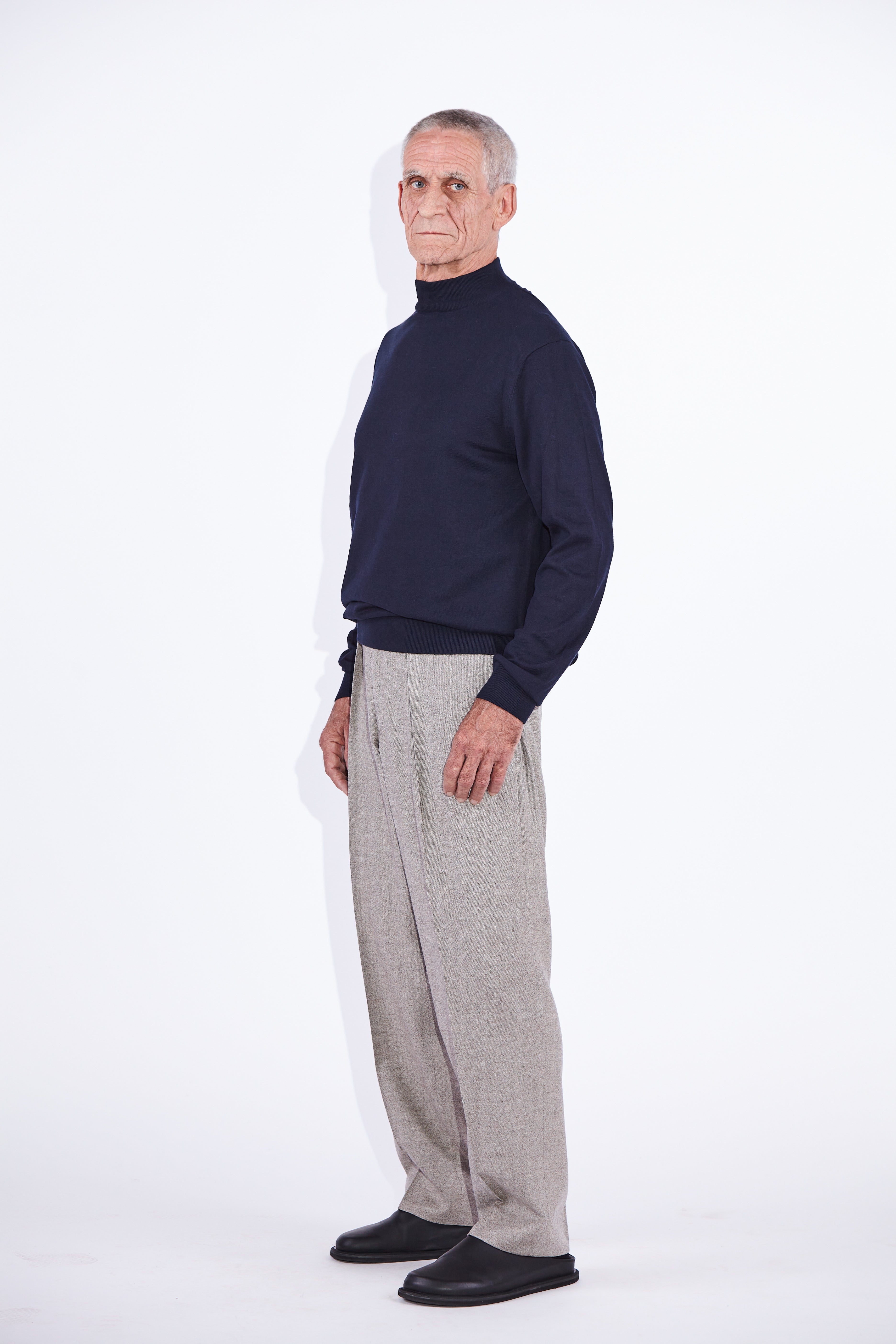 Model wears Casely-Hayford Stratis Navy High Crew Neck Knit Jumper. 