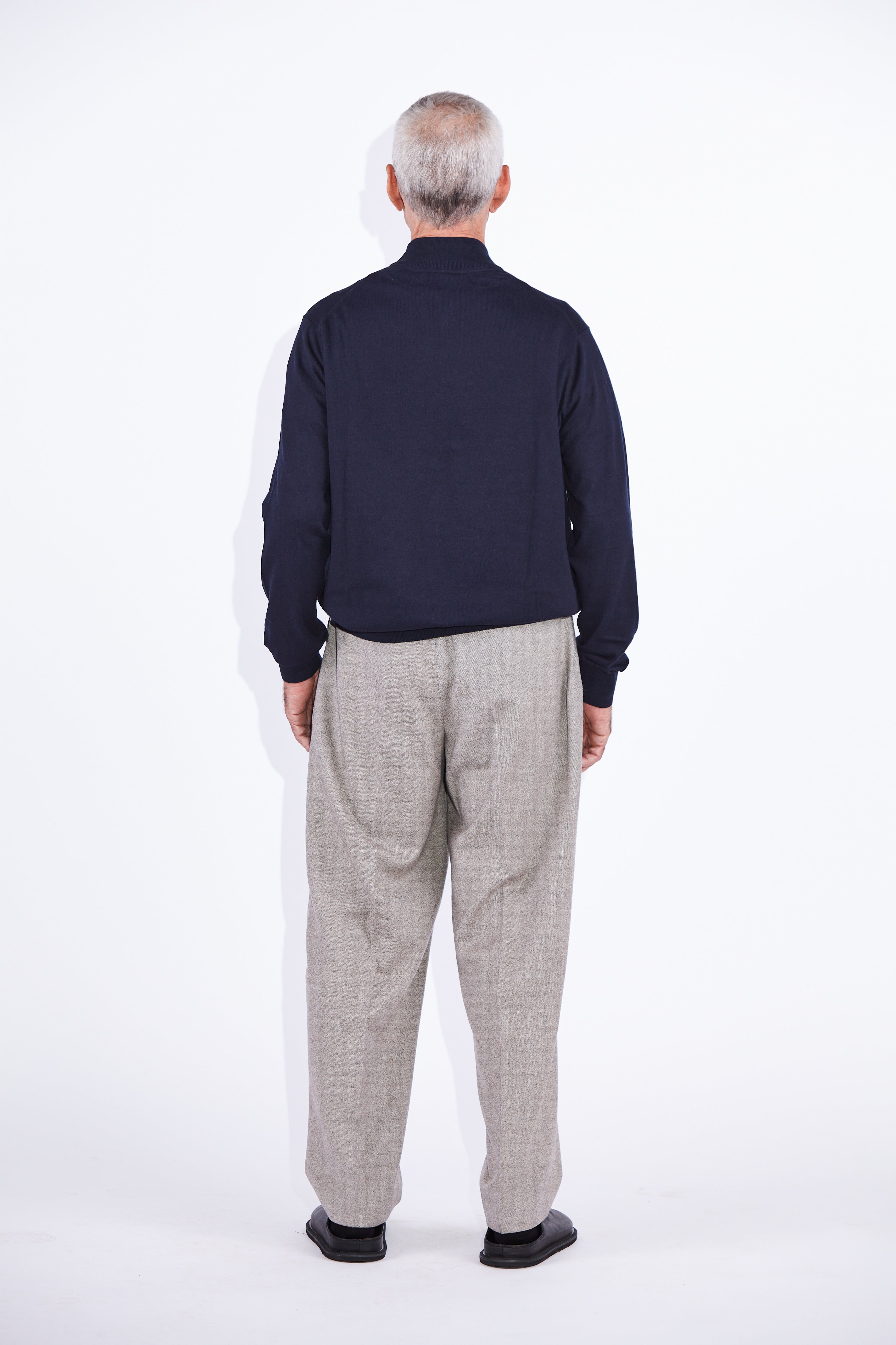 Model wears Casely-Hayford Stratis Navy High Crew Neck Knit Jumper. 