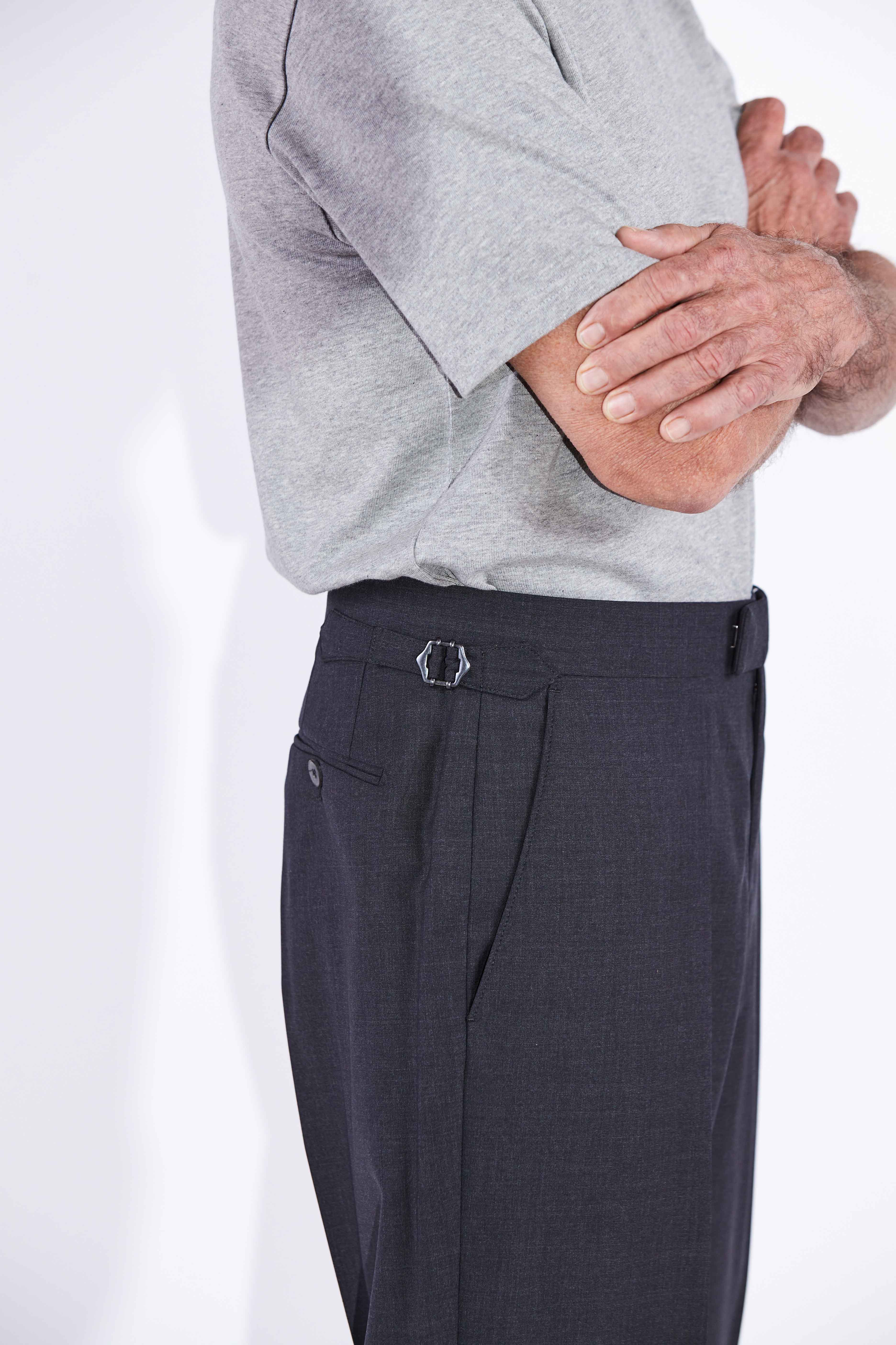 Model wears Casely-Hayford Ezra Anthracite Fresco Relaxed Tapered Leg Wool trousers.