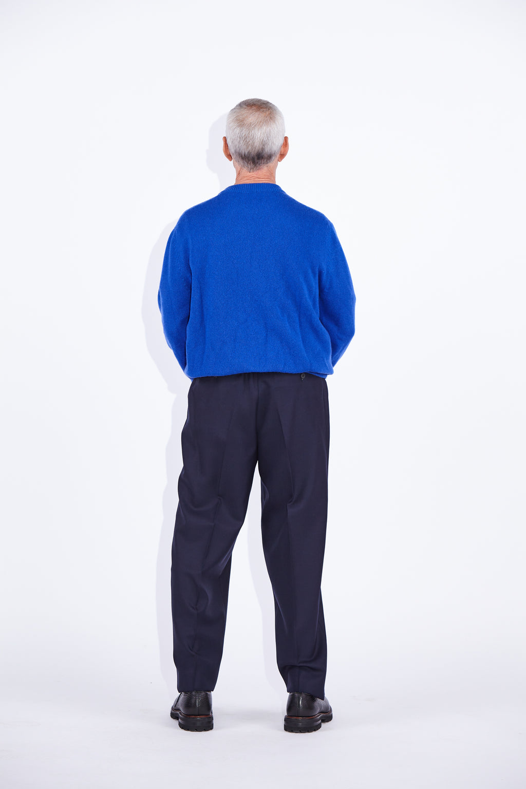 Model wears Casely-Hayford Rory Klein Cashmere Crew Neck Knit. 