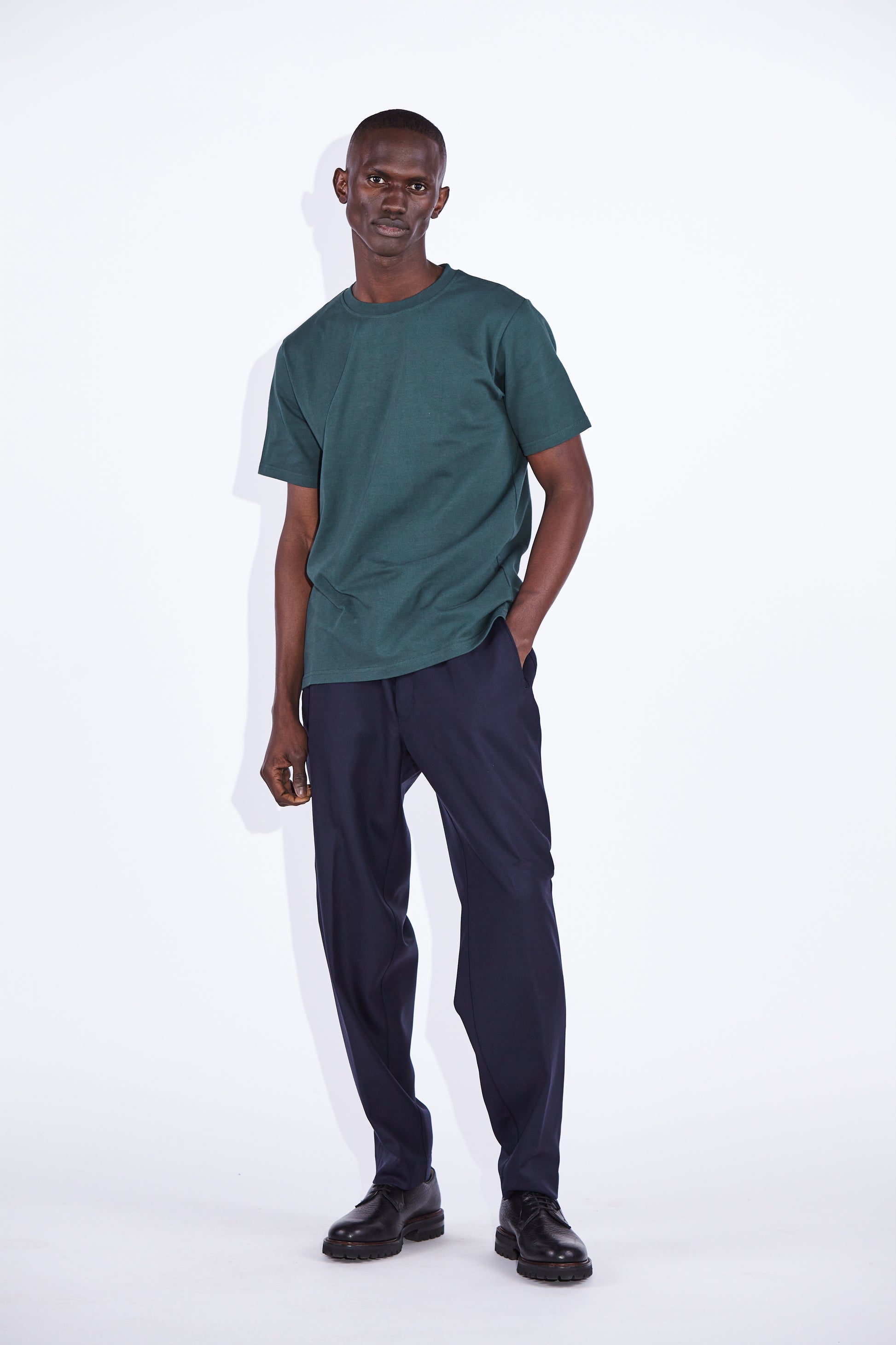 Casely Hayford Dejan Verde Relaxed Cotton T-shirt: Model is wearing a dark green deep neck trim, high crewneck t-shirt