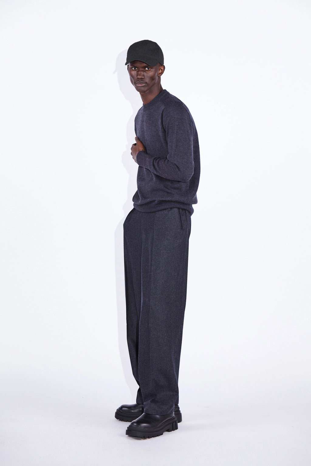 Model wears Casely-Hayford Nicolai Charcoal Merino Wool Knit. 