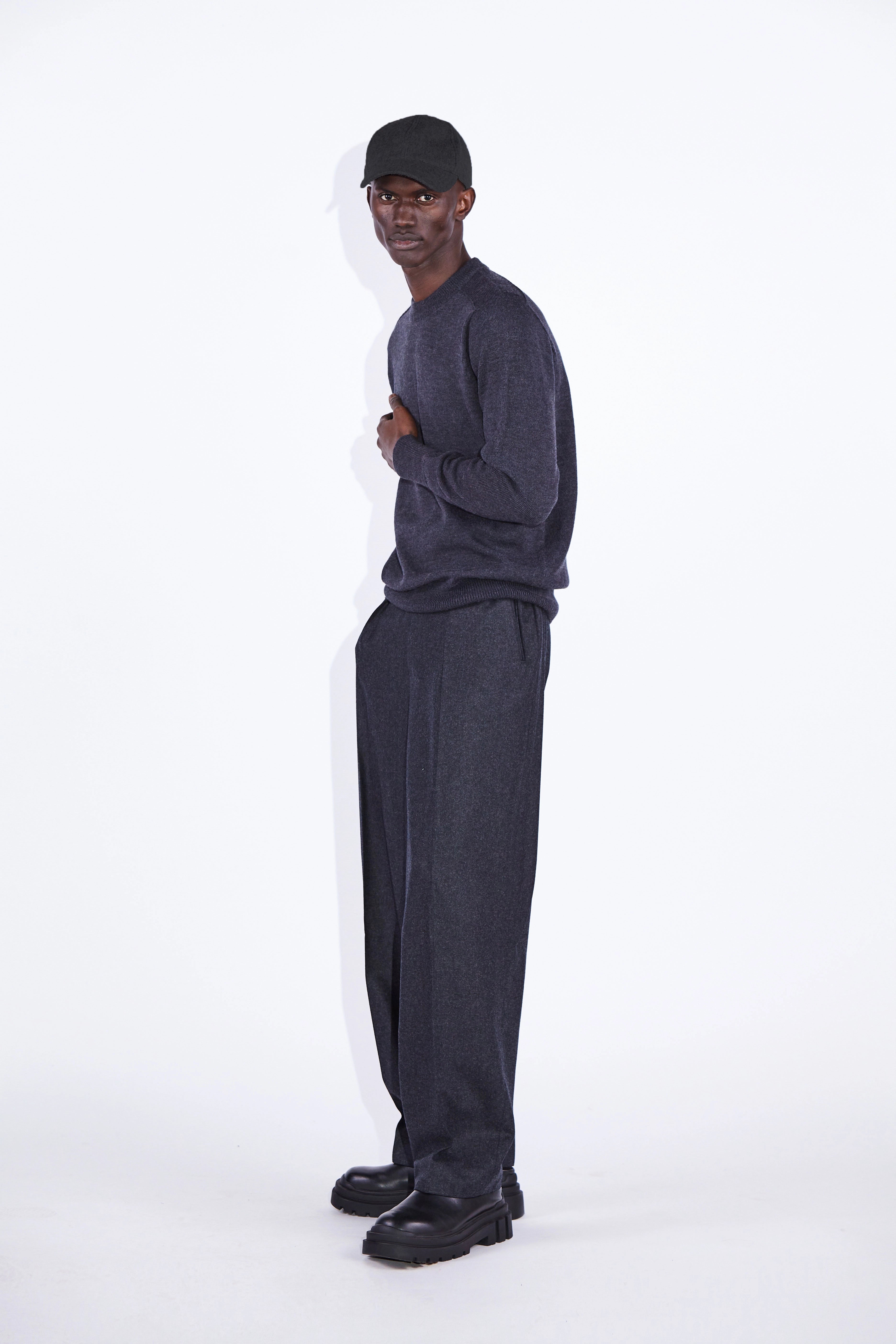 Model wears Casely-Hayford Nicolai Charcoal Merino Wool Knit. 
