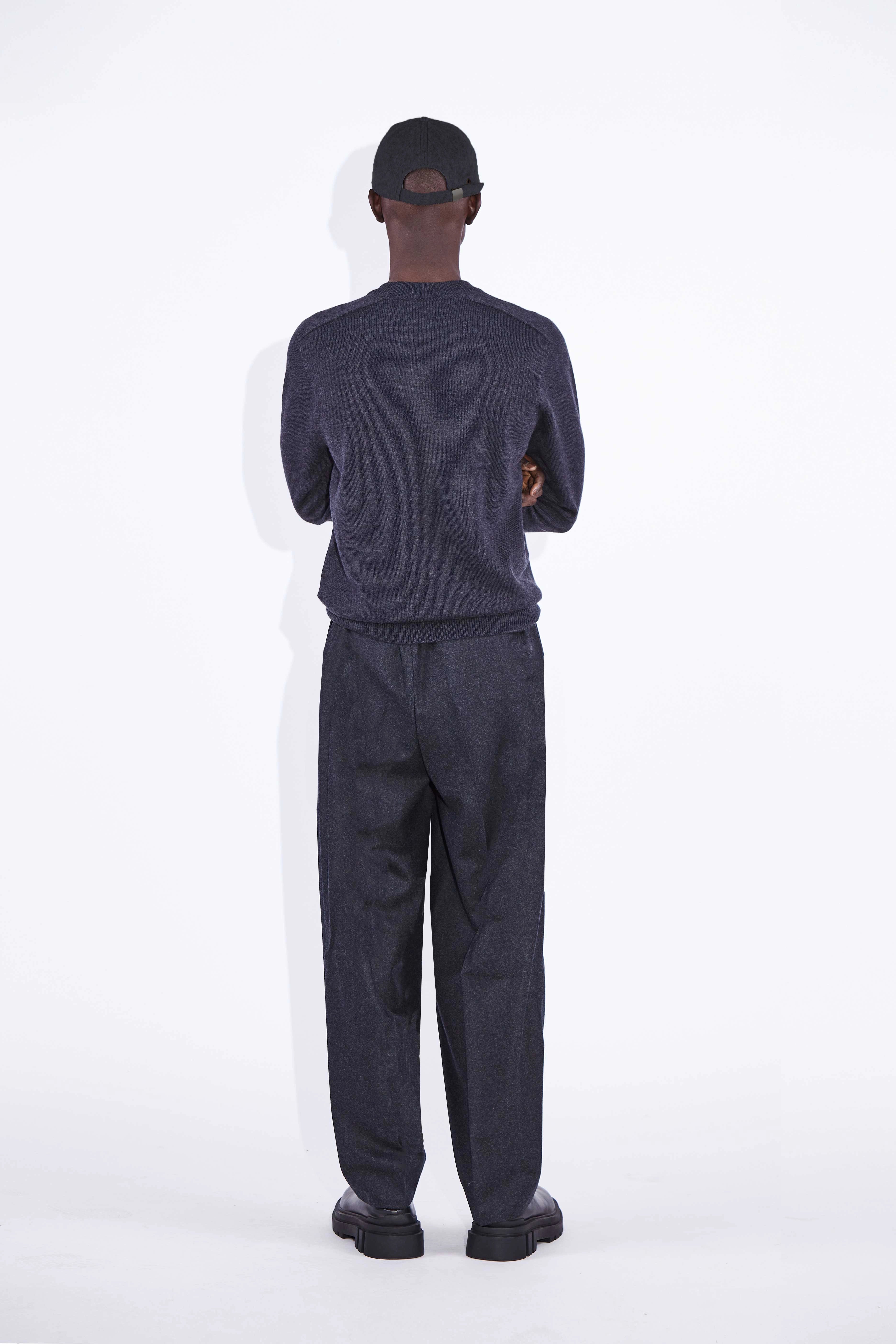 Model wears Casely-Hayford Nicolai Charcoal Merino Wool Knit. 