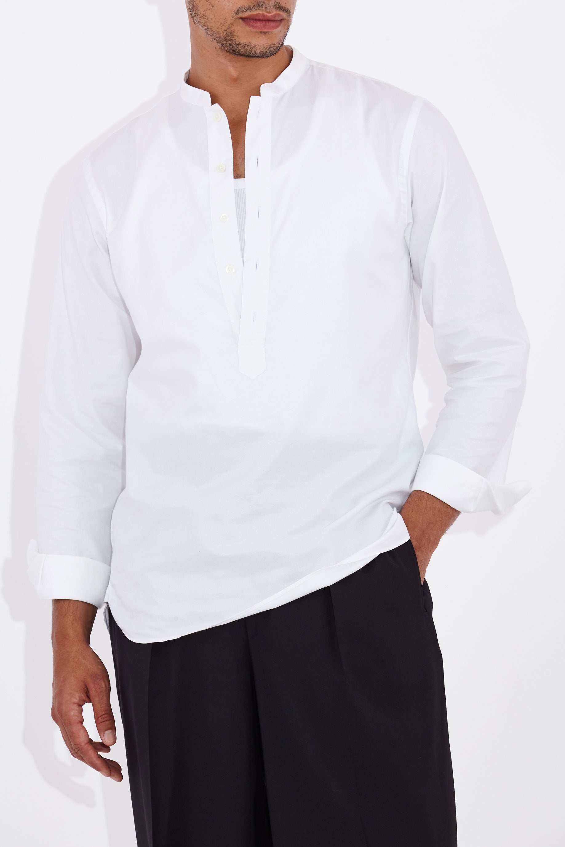 Model wears Casely-Hayford Tyler White Collarless Cotton Shirt. 
