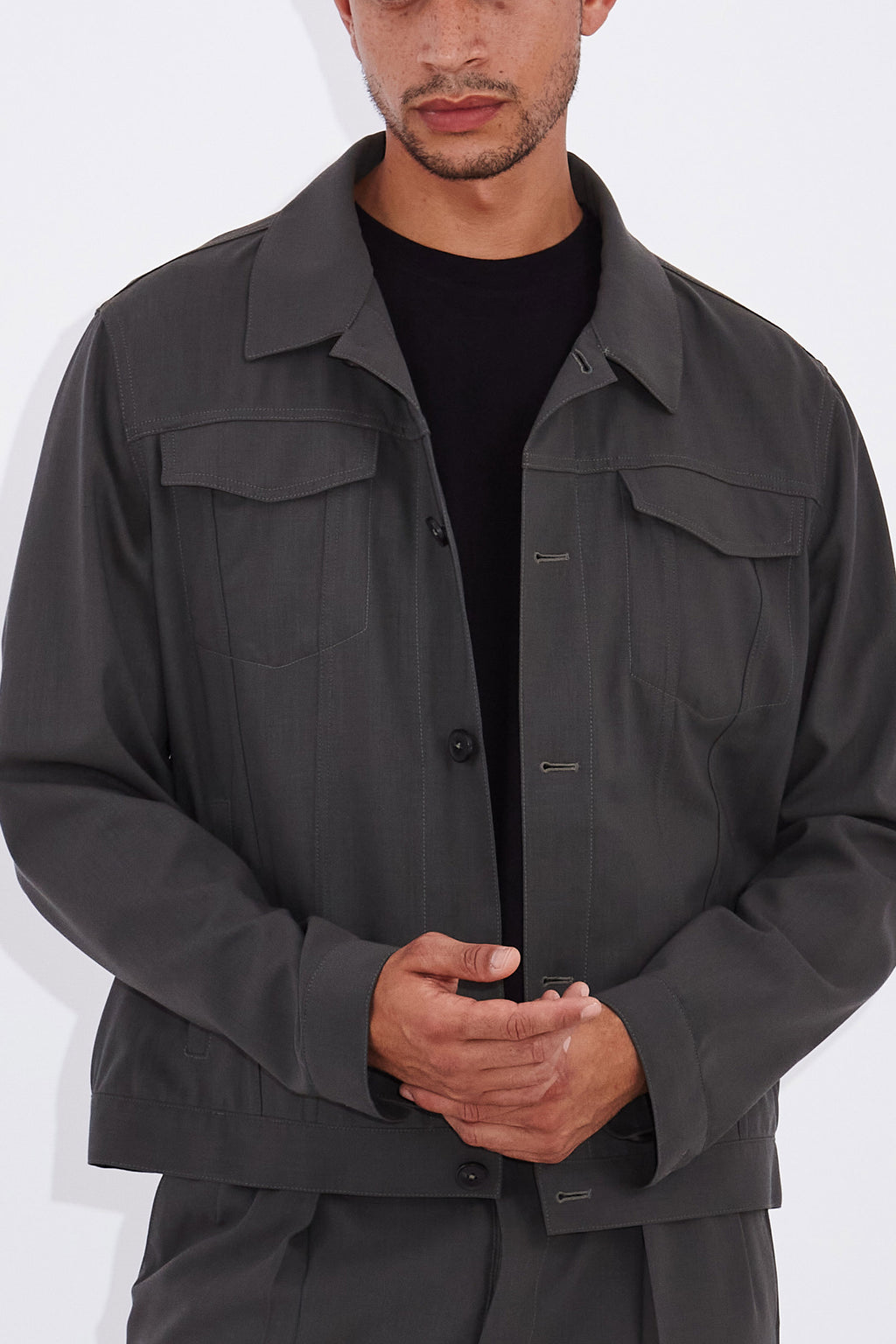 Model wears Casely-Hayford Axel Misty Olive Trucker Jacket. 