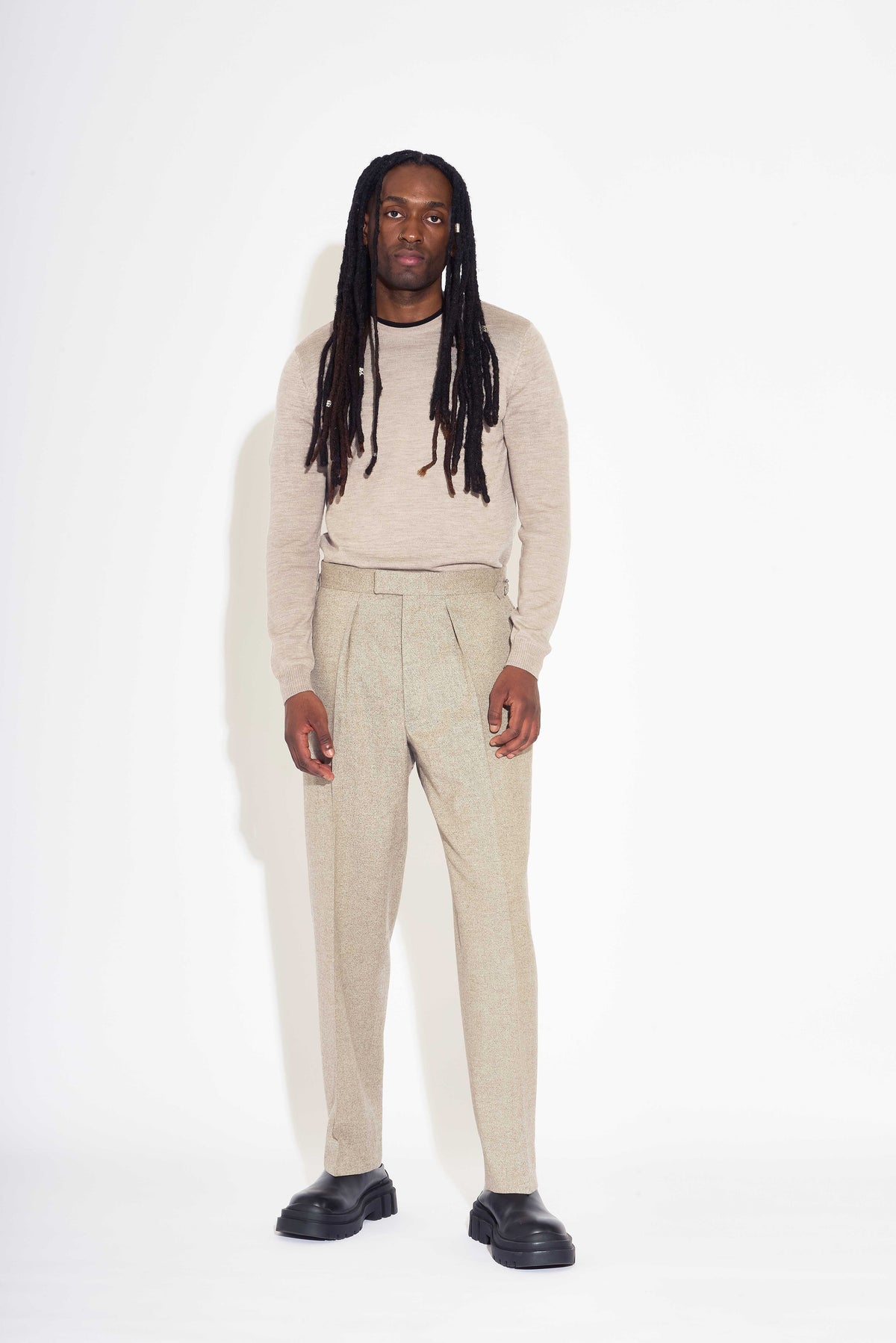 Model wears Casely-Hayford Fidel Sandalwood Straight Leg Wool Flannel Trousers.
