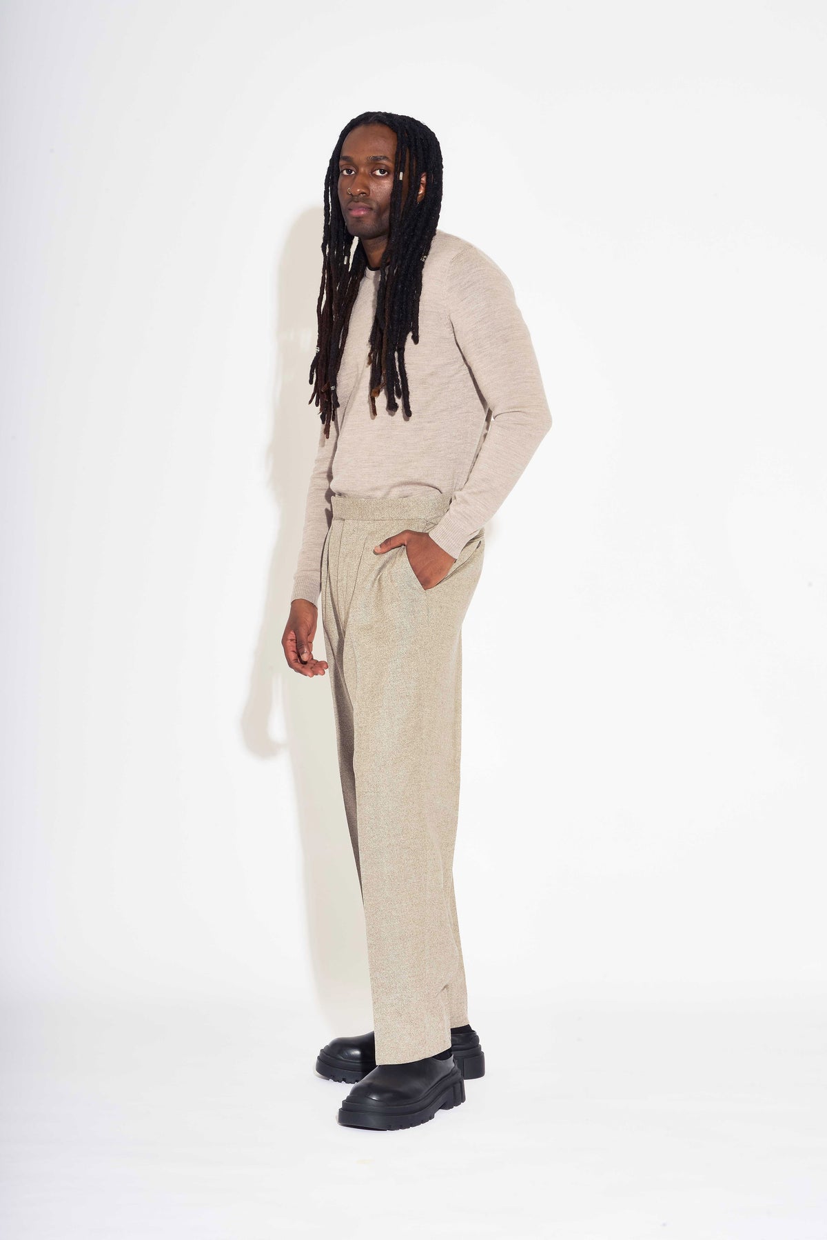 Model wears Casely-Hayford Fidel Sandalwood Straight Leg Wool Flannel Trousers.