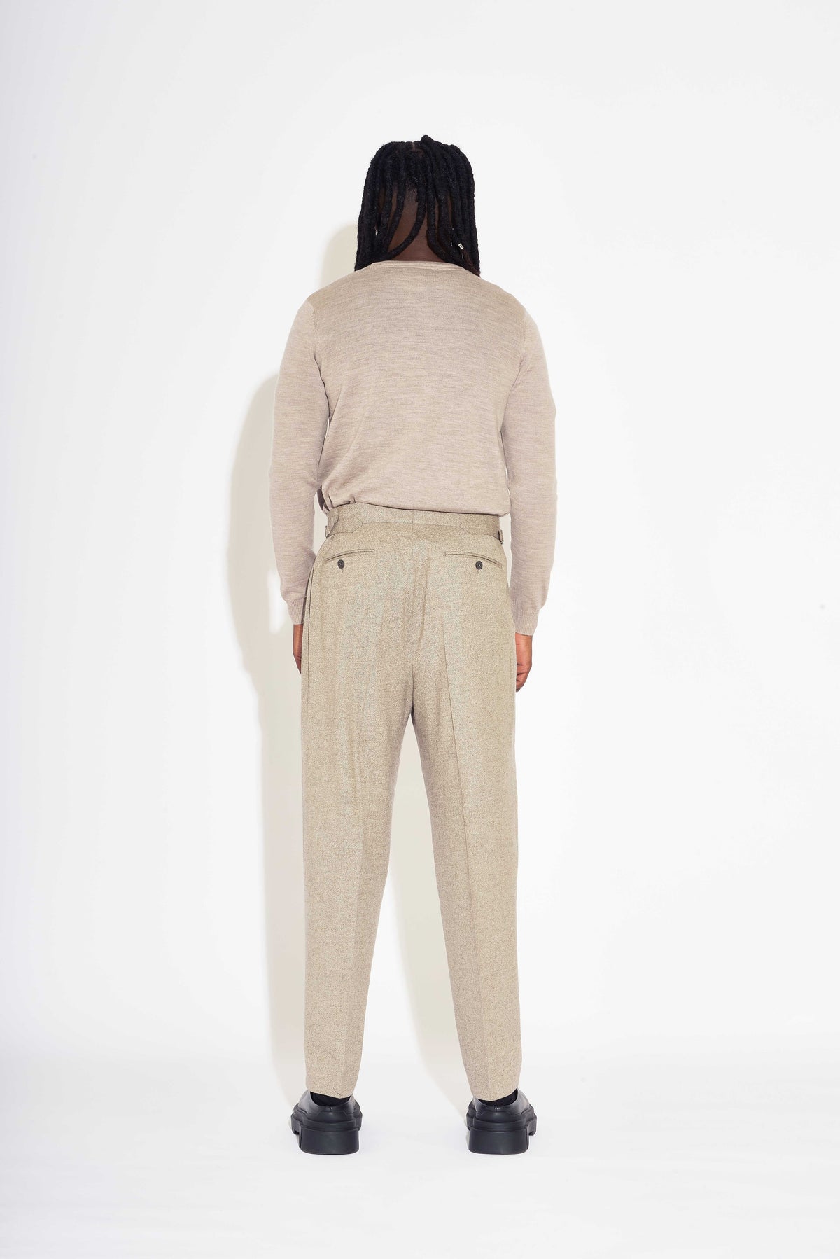 Model wears Casely-Hayford Fidel Sandalwood Straight Leg Wool Flannel Trousers.