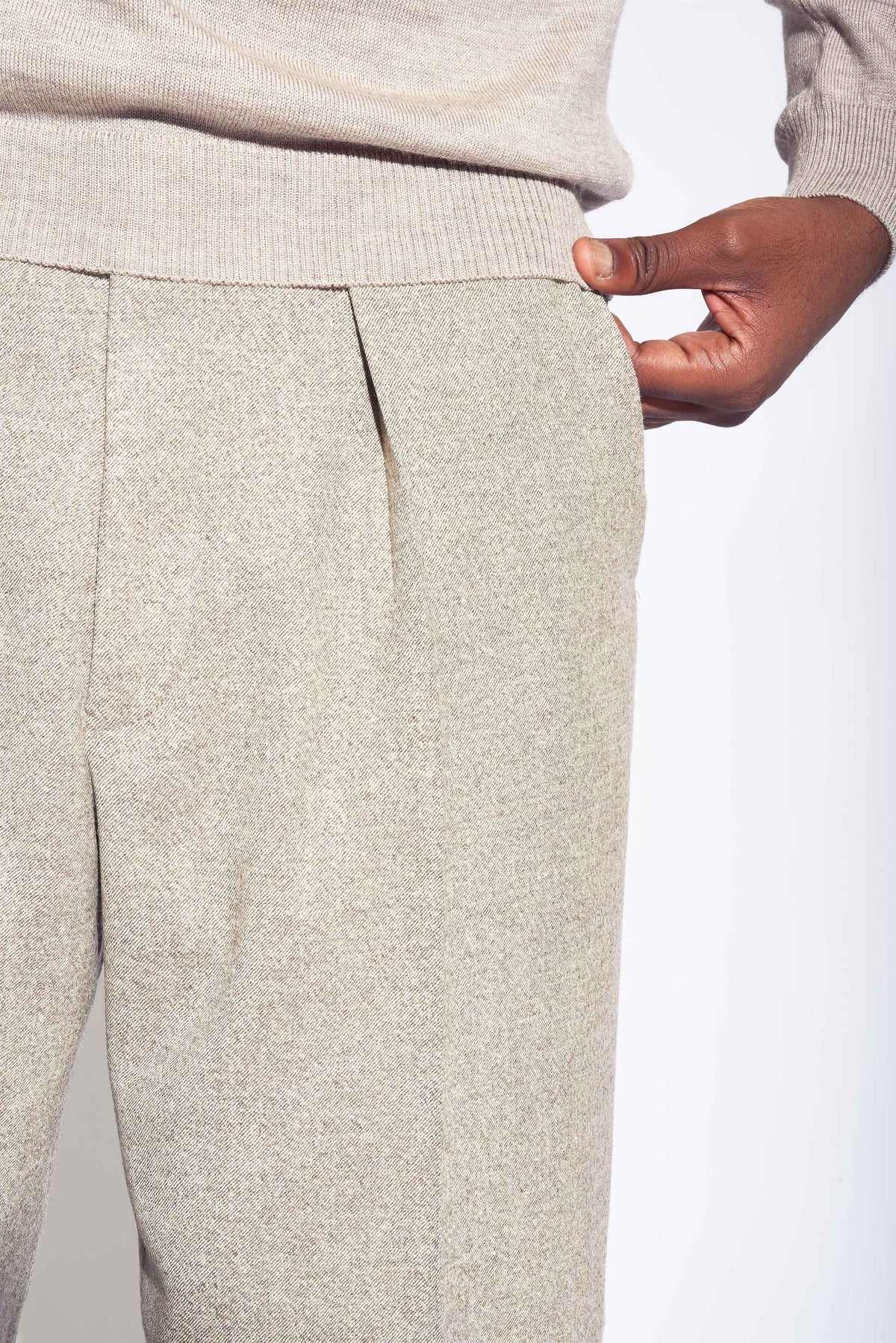 Model wears Casely-Hayford Fidel Sandalwood Straight Leg Wool Flannel Trousers.