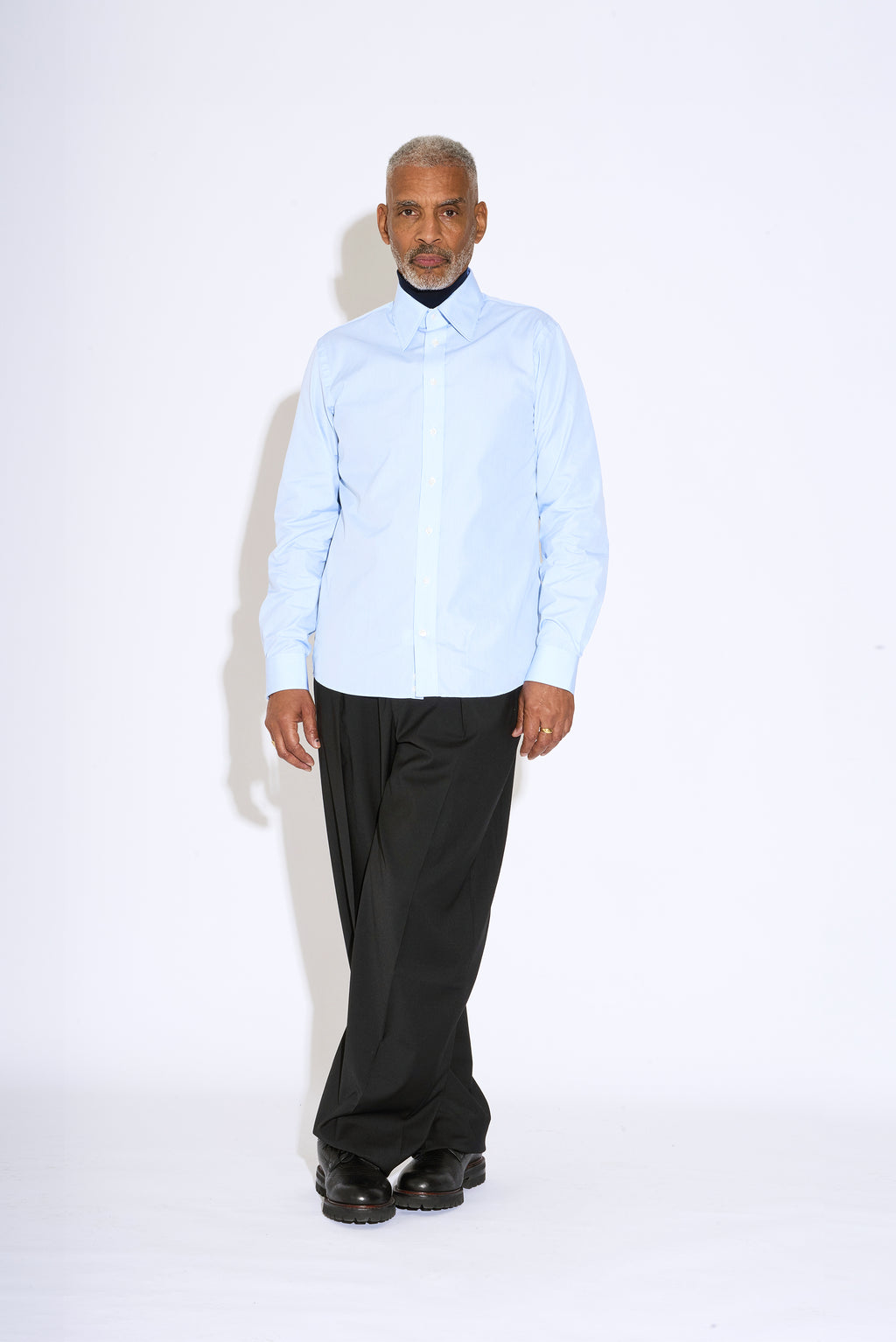 Model wears Casely-Hayford Duval Blue Stripe Long Point Collar Cotton Shirt. 