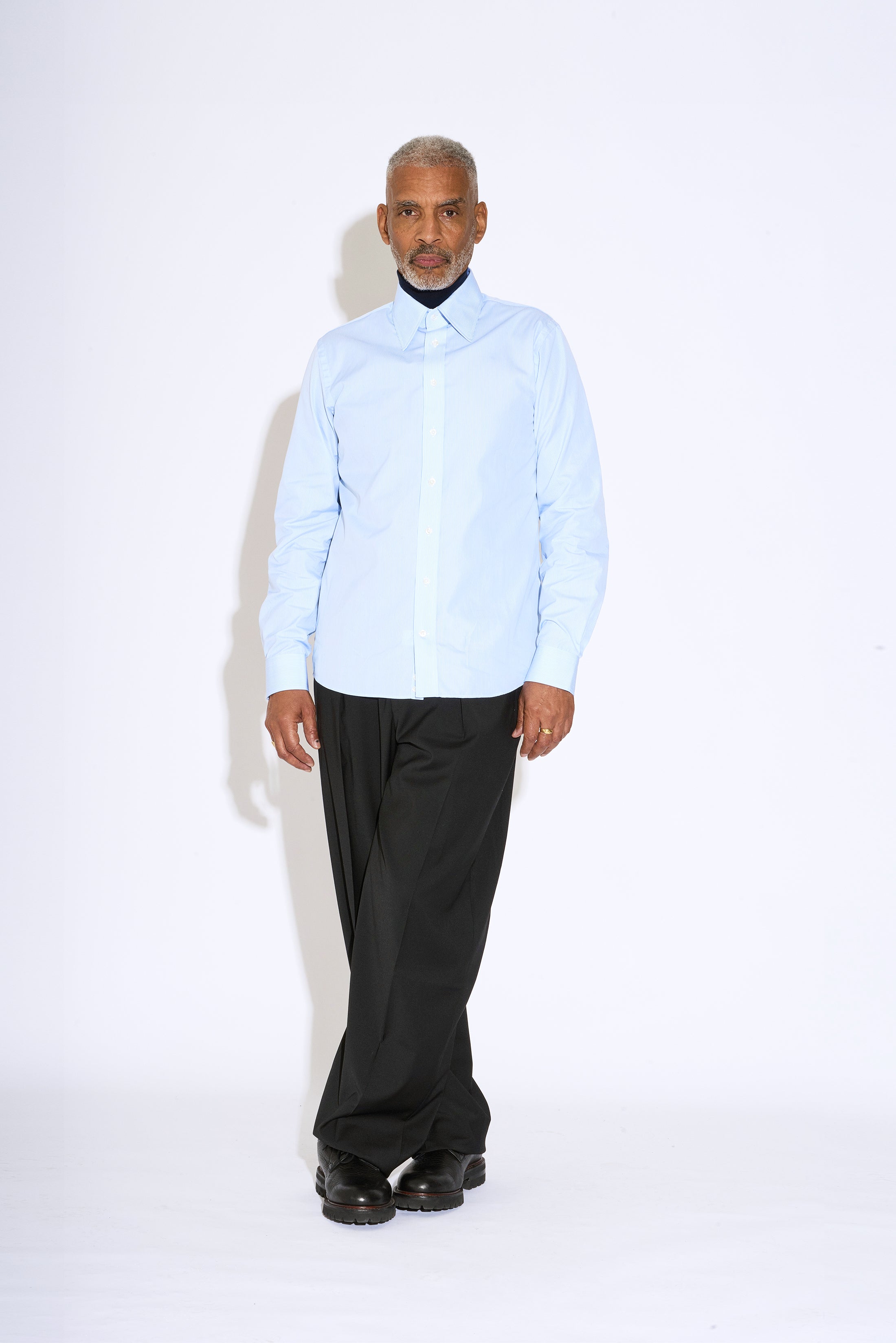 Model wears Casely-Hayford Duval Blue Stripe Long Point Collar Cotton Shirt. 