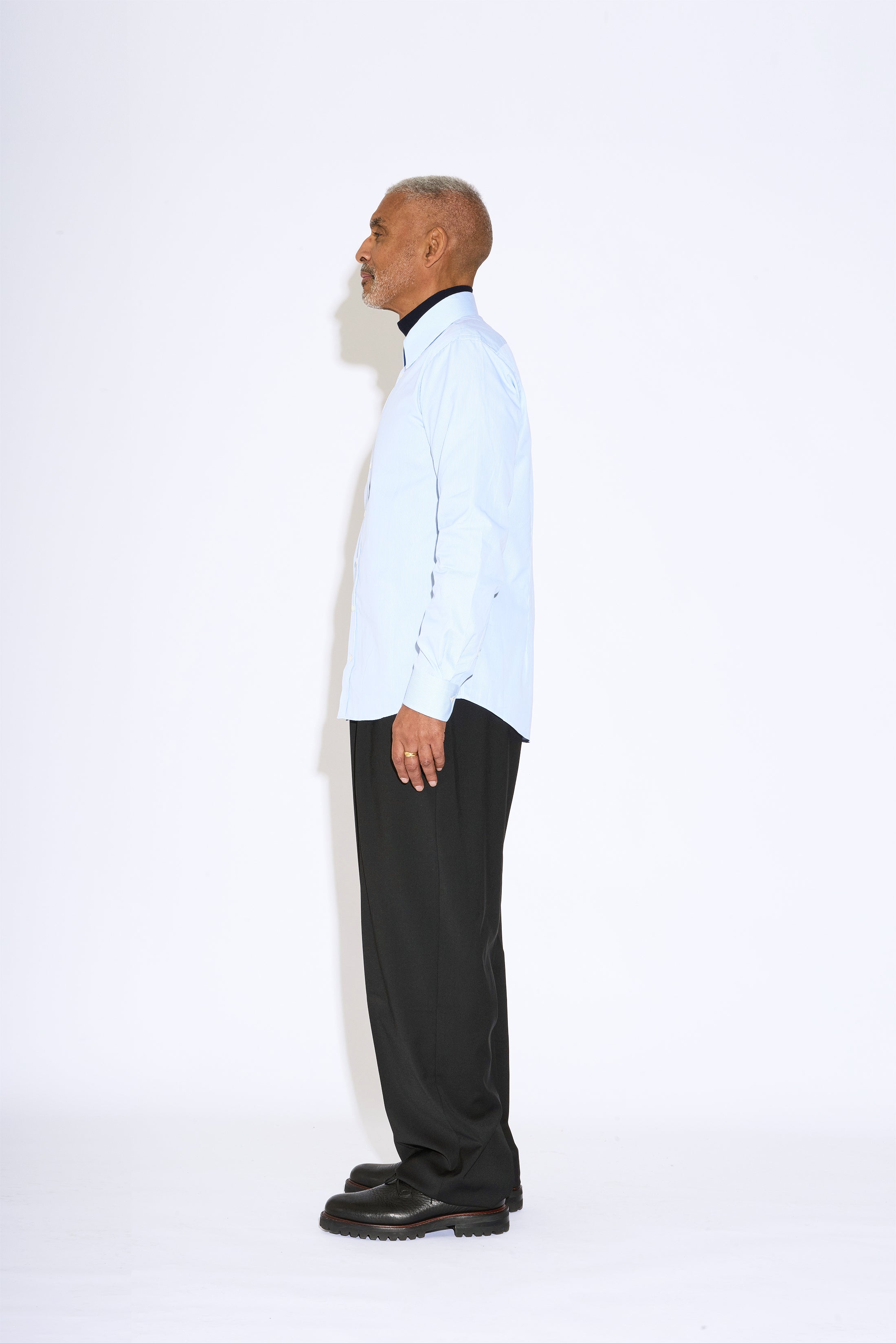 Model wears Casely-Hayford Duval Blue Stripe Long Point Collar Cotton Shirt. 