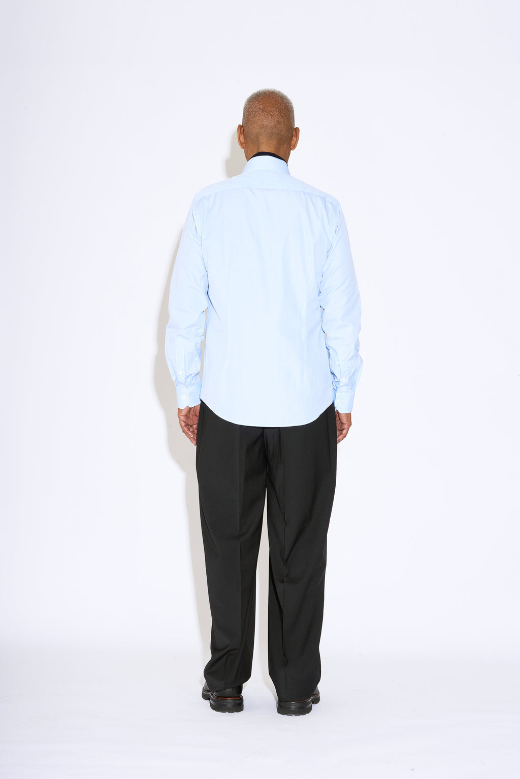 Model wears Casely-Hayford Duval Blue Stripe Long Point Collar Cotton Shirt. 