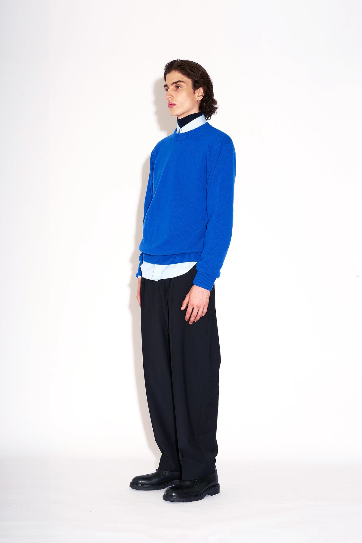 Model wears Casely-Hayford Hannes Black Wide Legged Wool Trousers.