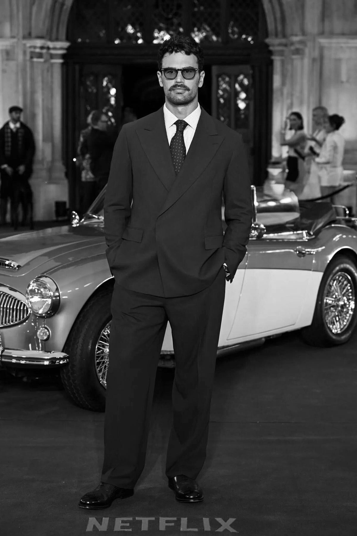The James wears a custom Casely-Hayford Christoph suit. Black and white image. 