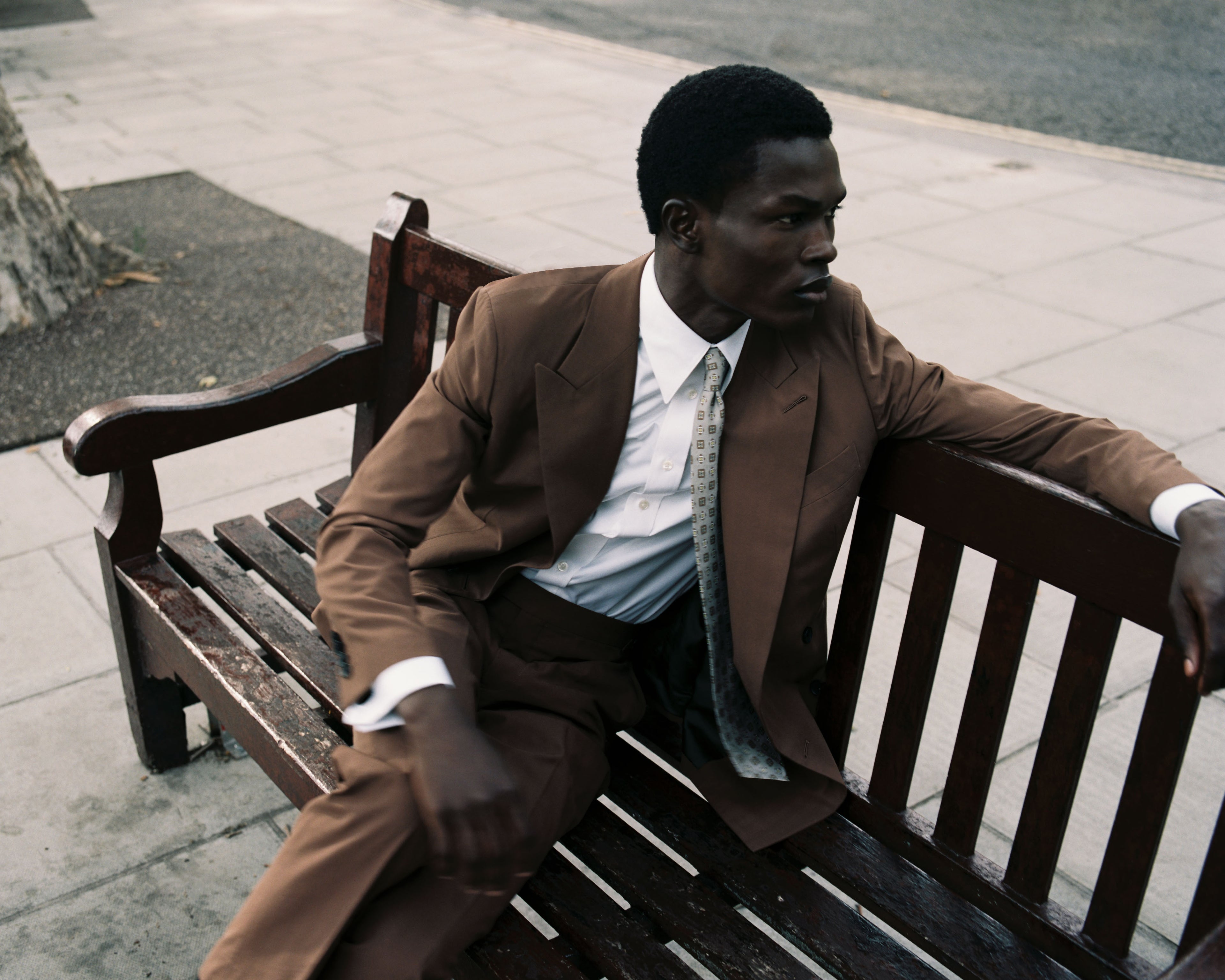 Model wears Casely-Hayford relaxed fit suit with Italian tie. 