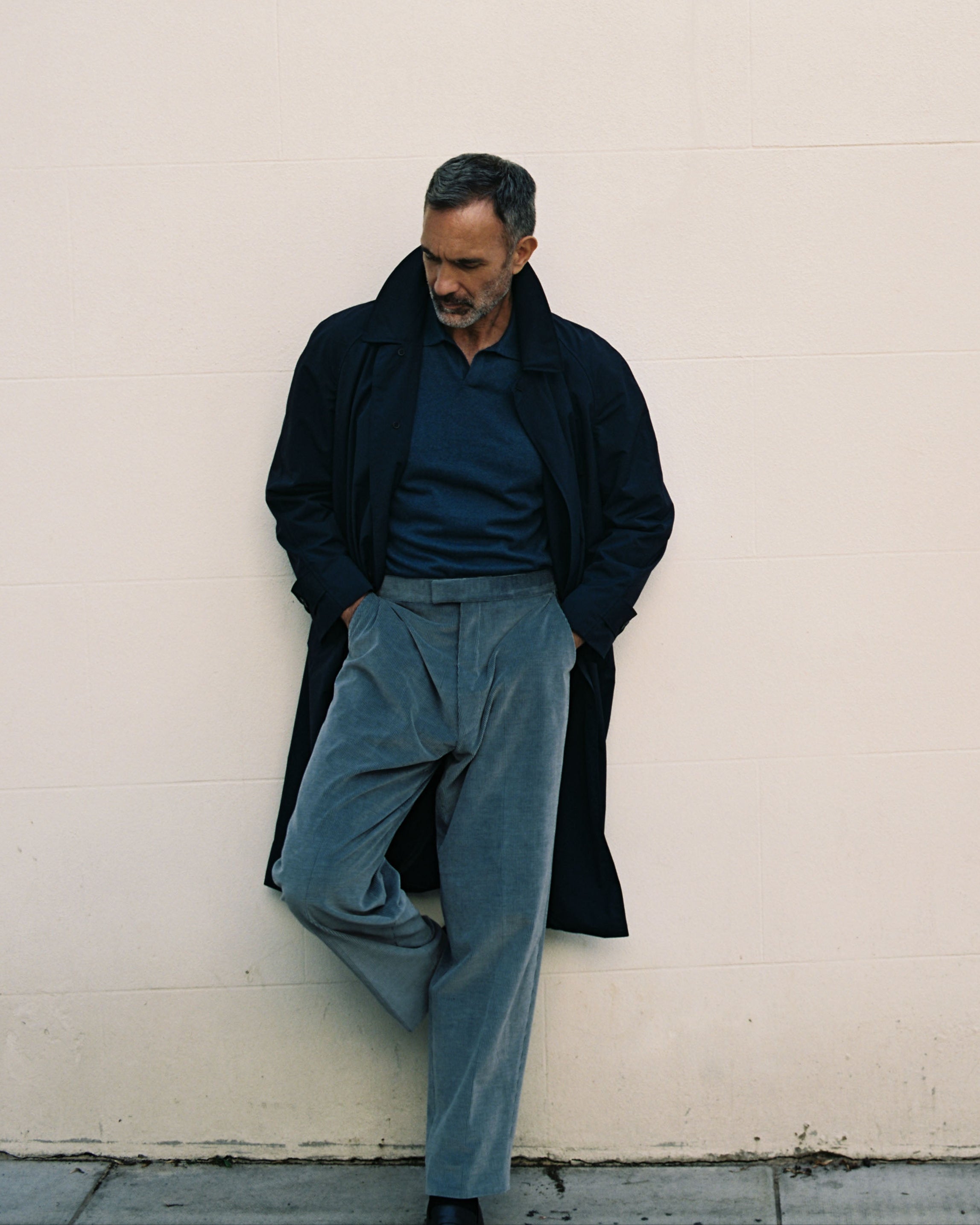 Model wear Casely-Hayford knit and Klee coat in blue and navy tones. 