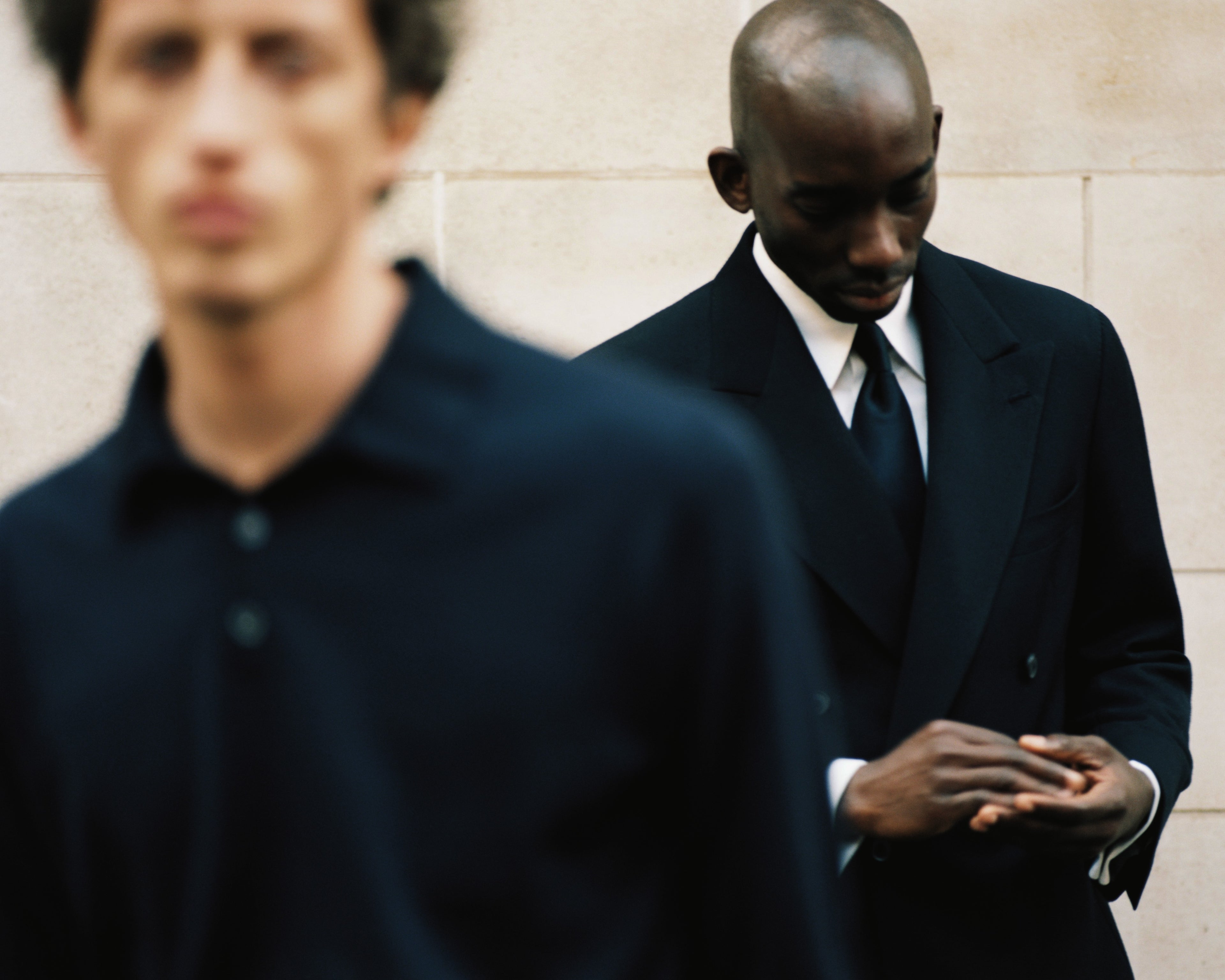 Two models wear Casely-Hayford, one in suit and other in casual knit. 