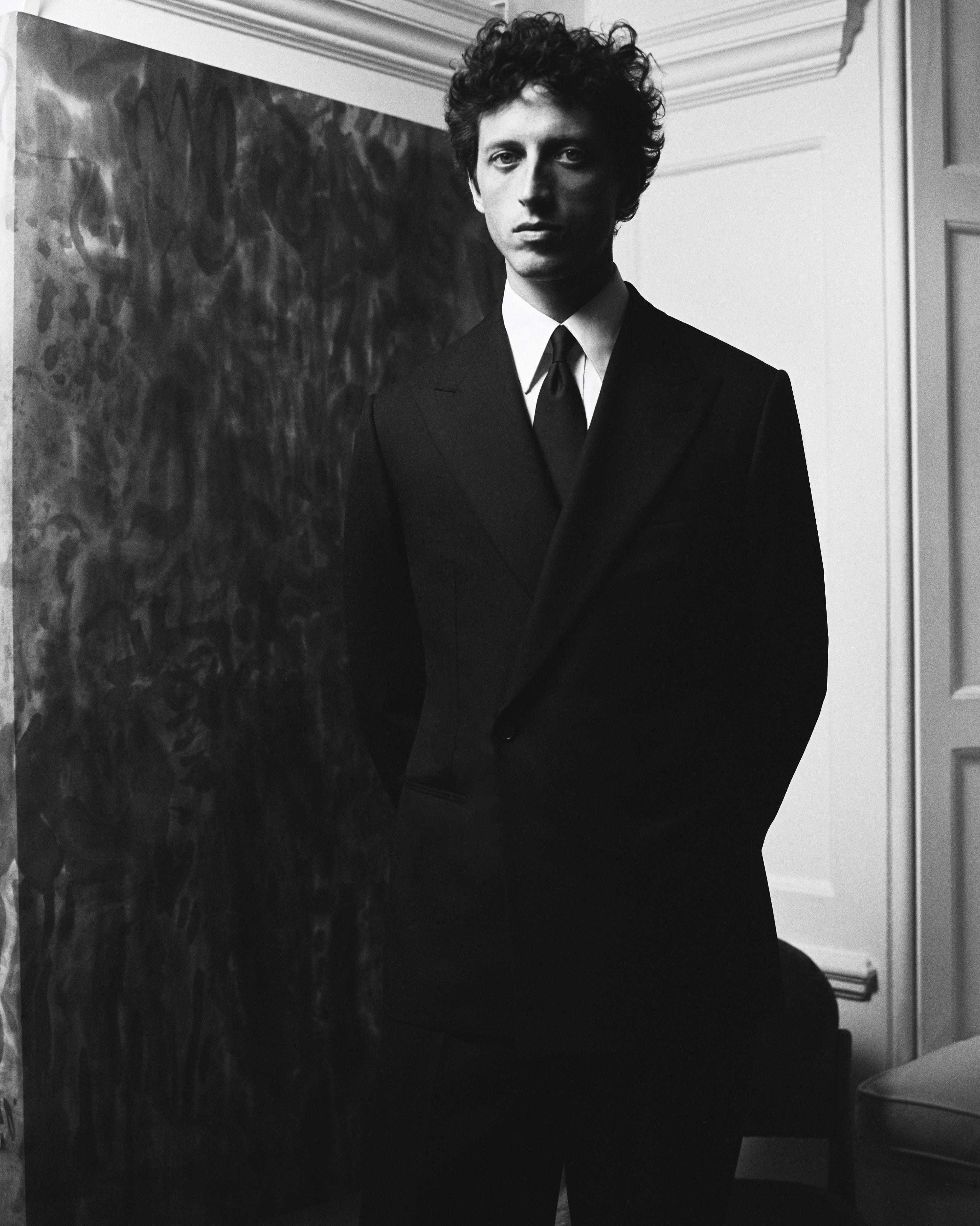 Black and white portrait of model wearing Casely-Hayford made-to-measure suit. 
