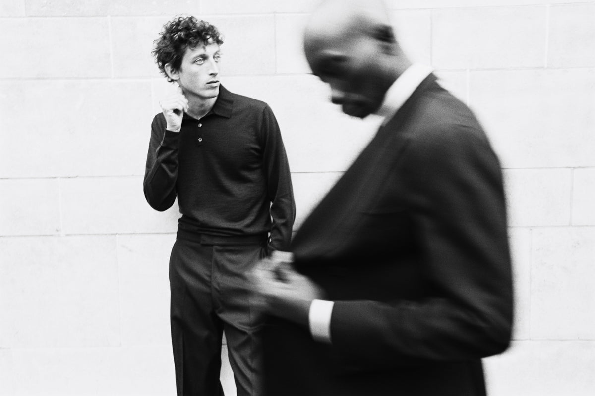 Model wears Casely-Hayford casual knit and trouser. With another model in from wearing a suit. 