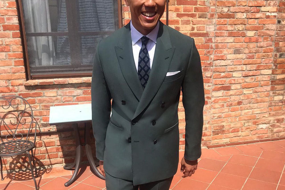 Groom wears Casely-Hayford made-to-measure Forest green double breasted suit . 