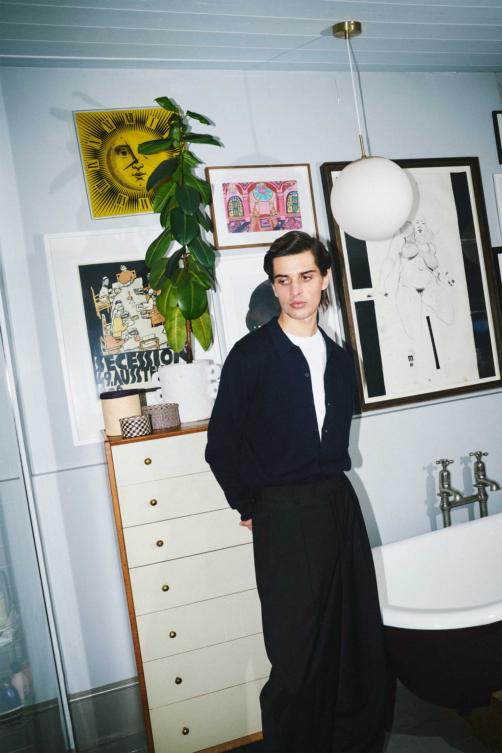 Model wears Casely-Hayford Aksel Navy Button Through Knitted Polo Cotton Shirt. 