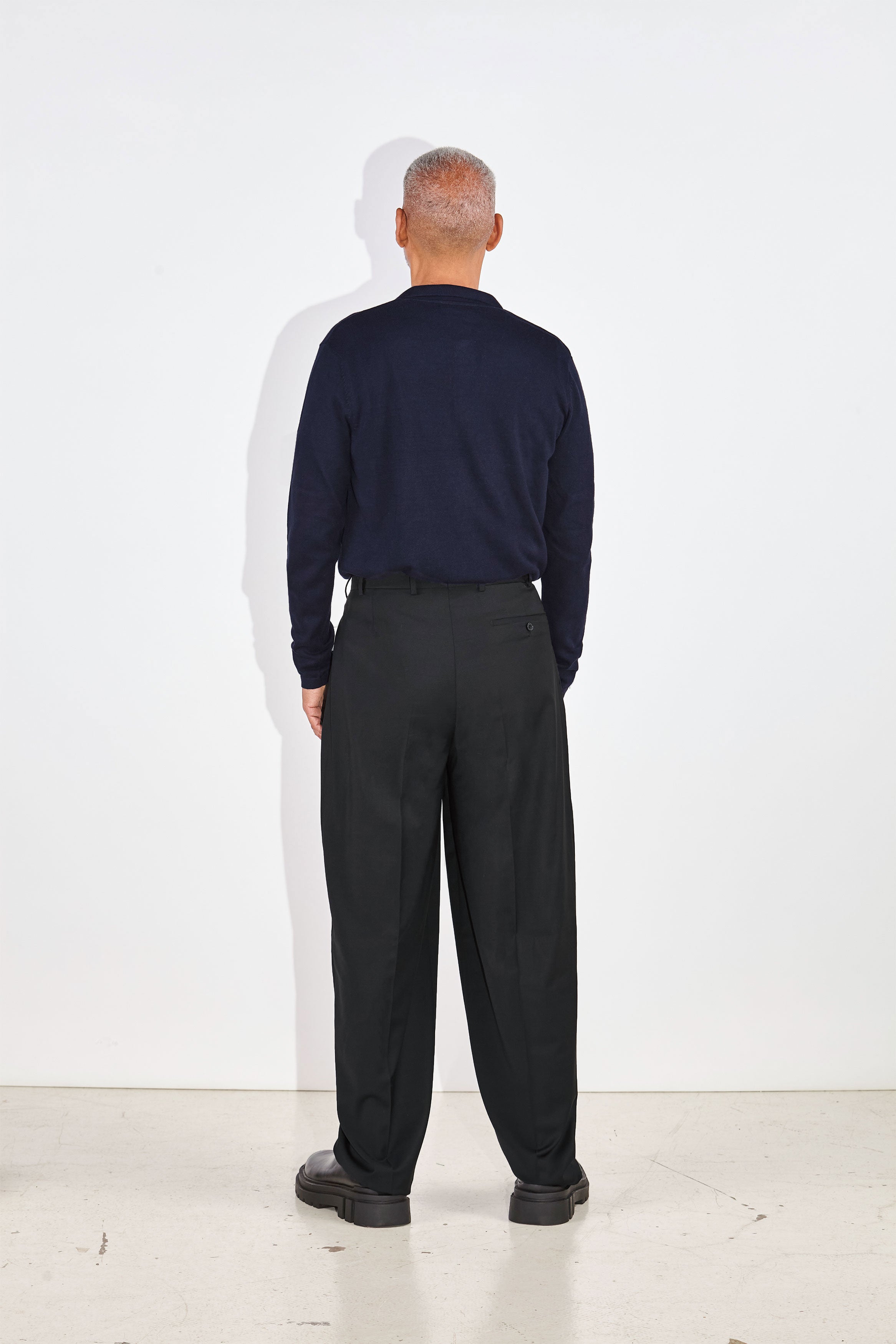 Model wears Casely-Hayford Aksel Navy Button Through Knitted Polo Cotton Shirt. 