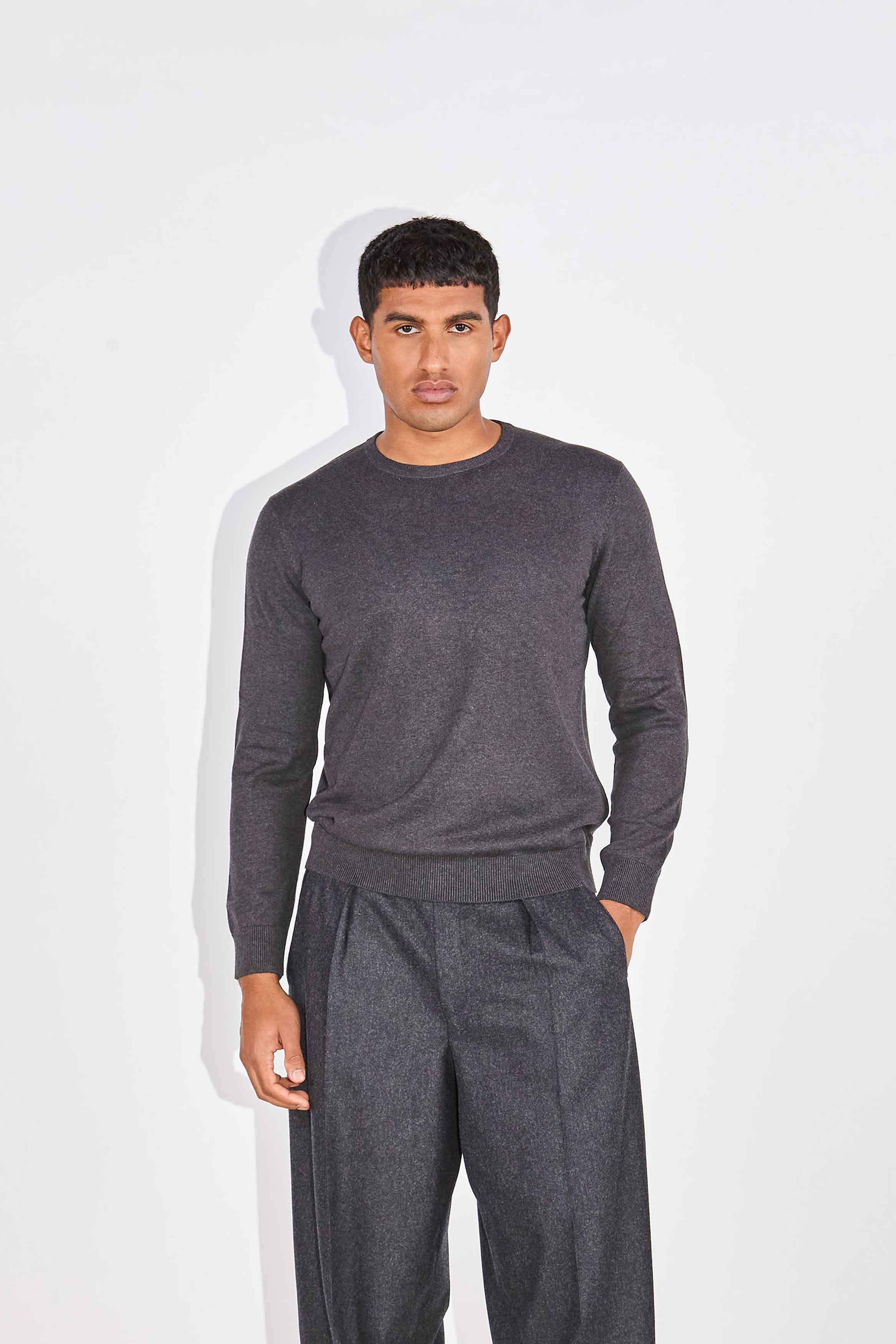 Model wears Casely-Hayford Augustin Charcoal Crew Neck Cotton Jumper.