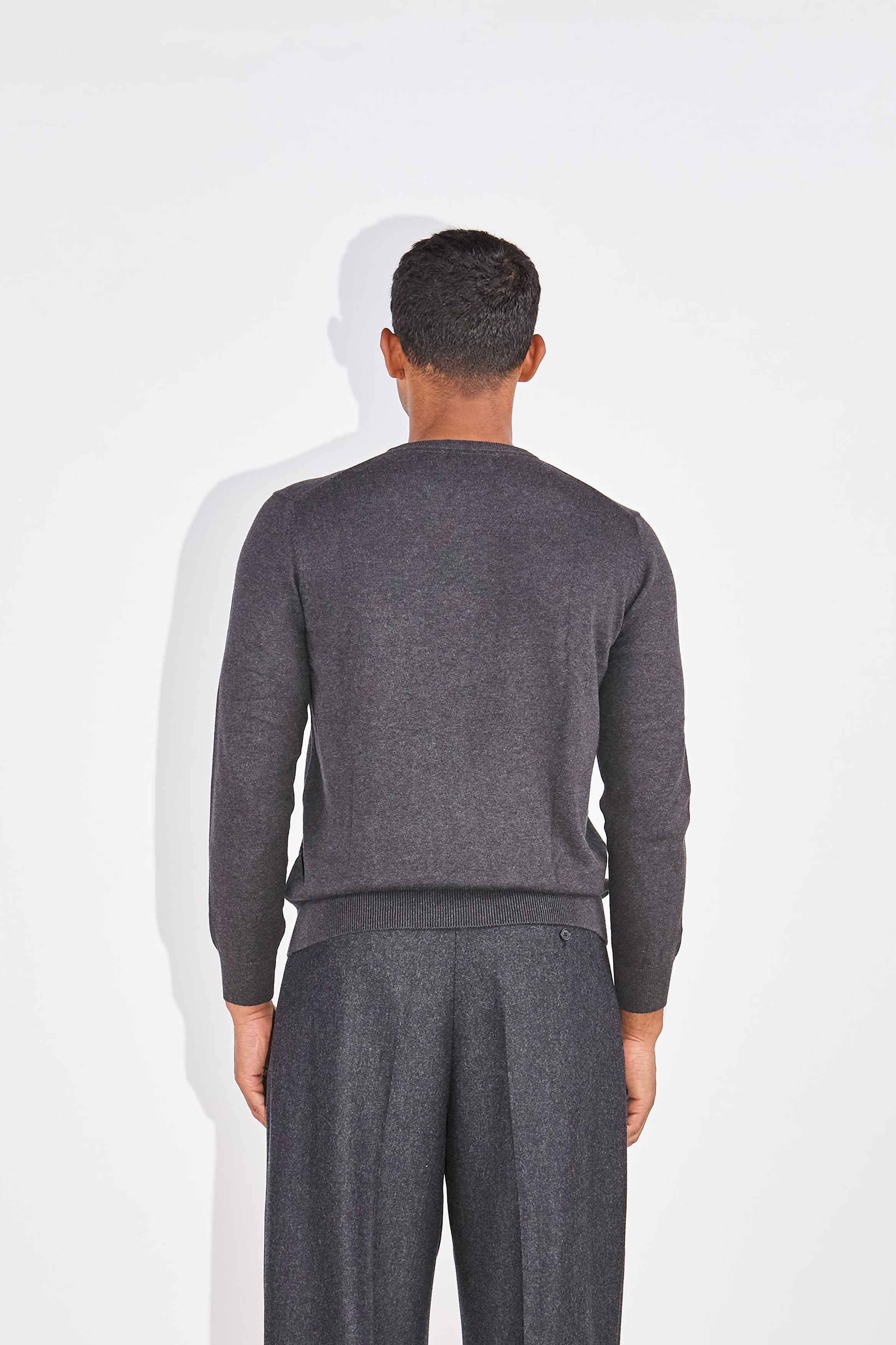 Model wears Casely-Hayford Augustin Charcoal Crew Neck Cotton Jumper.