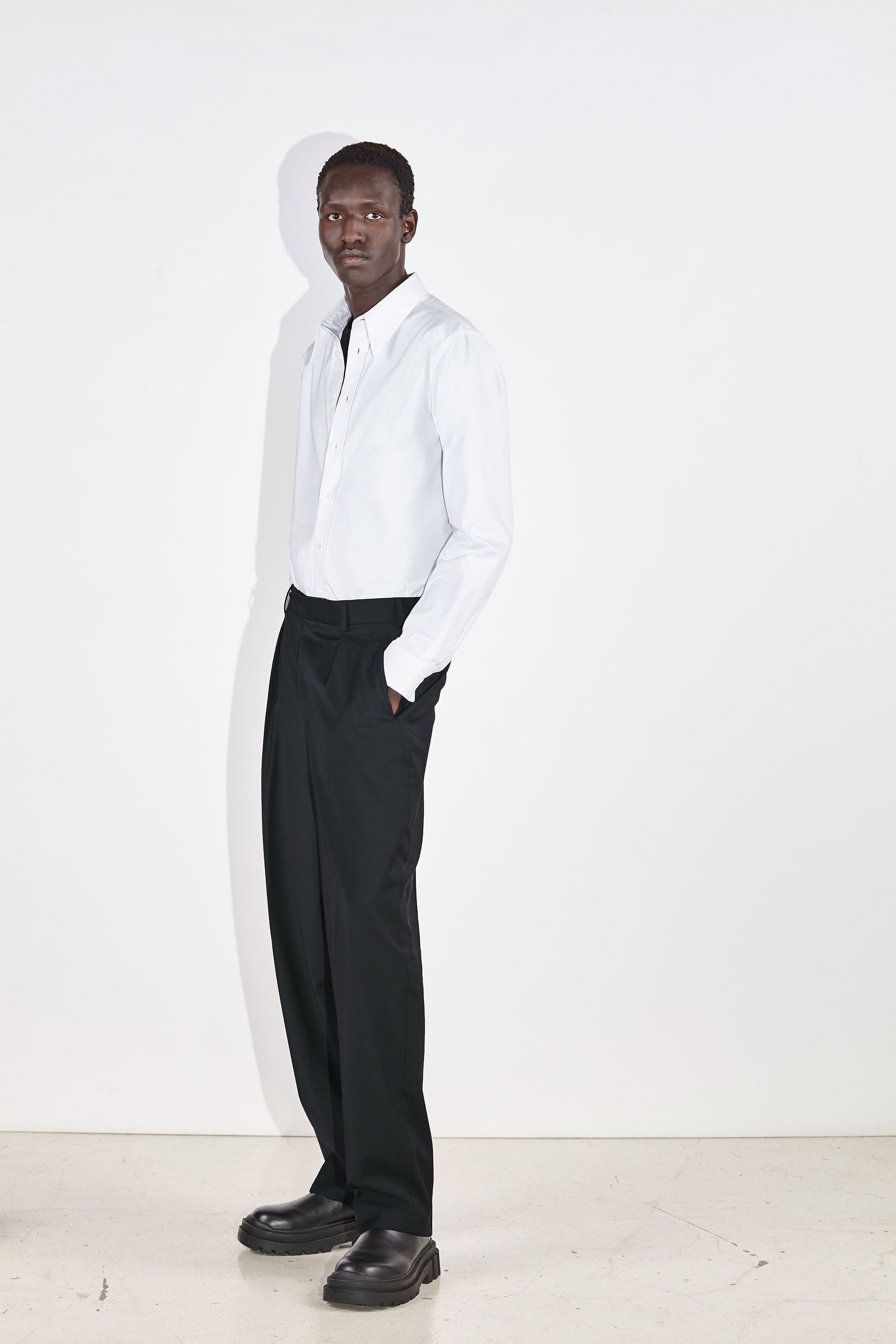 Model wears Casely-Hayford Duval White Long Point Collar Cotton Shirt. 